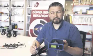  ?? ?? Researcher and professor Sinan Kıvrak holds the mobile electrocau­tery device developed at OSTİM Technical University, Ankara, Turkey, May 13, 2022.