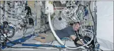  ?? CHRIS HADFIELD/ TWITTER ?? Chris Hadfield vacuums the space station’s air filters in zero gravity.