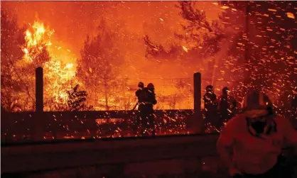  ?? ?? In August 2021, wildfires spread across northern Athens, Greece, as temperatur­es reached 42C (107.6F). Photograph: Miloš Bičanski/Getty Images