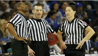  ?? ASSOCIATED PRESS FILE PHOTO ?? Officials Eric Brewton, left, Joe Vaszily, center, and Maj Forsberg stand during a timeout in a 2017 women’s hoops game.