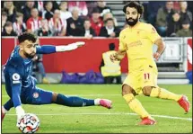  ?? ?? Liverpool’s Mohamed Salah (right), scores his side’s second goal during the English Premier League soccer match between Brentford and Liverpool at the Brentford Community Stadium in London. (AP)