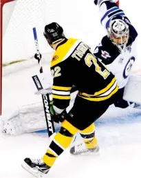  ?? (Reuters) ?? BOSTON BRUINS forward Shawn Thornton scores on a second-period penalty shot past Winnipeg Jets goalie Ondrej Pavelec during the Bruins’ 5-3 home victory on Tuesday night.