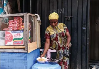  ?? Photo by Benson Ibeabuchi / AFP ?? A chef prepares noodles for her customer at the Lagos island market in Lagos on March 8, 2024, ahead of the holy fasting month of Ramadan.