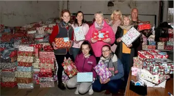  ??  ?? Volunteers packing shoe boxes at Celtic Linen last Christmas: Julie Berridge, Lorna Burt, Ciara Donnelly, Liz Jordan, Aileen Codd, Olivia Madigan, Sue Tobin and John Madigan.