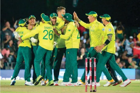  ?? — AFP ?? South Africa’s captain Quinton de Kock (2nd L) celebrates with team-mates their victory over England during the first T20 at the Buffalo Park in East London.