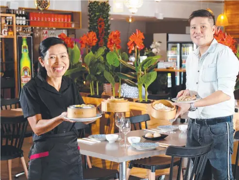  ??  ?? Waitress Melinda Kelly and manager Ray Sou serving up tasty food at Yum Sing in Lake Street. Picture: Stewart McLean