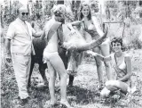  ??  ?? Gold Coast Mayor Sir Bruce Small on tour with the Meter Maids in the 1960s.