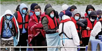  ?? ?? Journey’s end? Migrants are brought into Dover by Border Guard staff yesterday