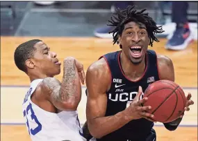  ?? Kathy Willens / Associated Press ?? UConn forward Isaiah Whaley (5) reacts as Seton Hall guard Shavar Reynolds collides with him during the second half on Wednesday.