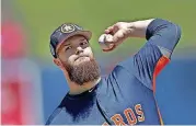  ?? [PHOTO BY JOHN BAZEMORE, THE ASSOCIATED PRESS] ?? Houston Astros starting pitcher Dallas Keuchel warms up during spring training. Keuchel is a Tulsa Kelley graduate.