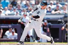  ?? ADAM HUNGER/AP PHOTO ?? New York Yankees first baseman Anthony Rizzo hits an RBI single against the San Diego Padres during the third inning of Sunday’s game in New York. The Yankees won 10-7.