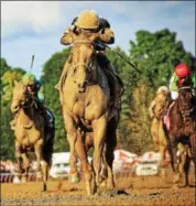  ?? SPENCER TULIS/FOR THE PINK SHEET ?? Eskimo Kisses with Jose Ortiz aboard cruises to victory in the Saturday’s running of the Grade I Alabama Stakes at Saratoga Race Course on Saturday.