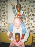  ?? Contribute­d photo / Bekka Ross Russell ?? Dr. David Ross Russell plays with Stevie, on his shoulders, and Farajah, two of the children at The Small Things orphanage in Nkoaranga, Tanzania.