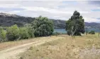  ?? PHOTO: ADAM BURNS ?? Lake trail . . . Clouds sit over Lake Dunstan near the Lowburn Cutting. The site is along a proposed cycleway from Cromwell to Wanaka, and where fencing is proposed to block vehicle access to the lake.