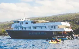  ??  ?? The national marine sanctuary teems with life, including dolphins, left. A great way to see them is through Uncruise Adventures, where the Safari Explorer, right, holds guided paddles.