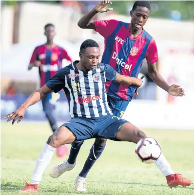 ?? GLADSTONE TAYLOR/MULTIMEDIA PHOTO EDITOR ?? Garrington Baker of Jamaica College (foreground) defends against Sekani Campbell of St Andrew Technical (STATHS) in their ISSA/Digicel Manning Cup quarter-final fixture at Stadium East on Tuesday, November 12, 2019. STATHS won 2-1.