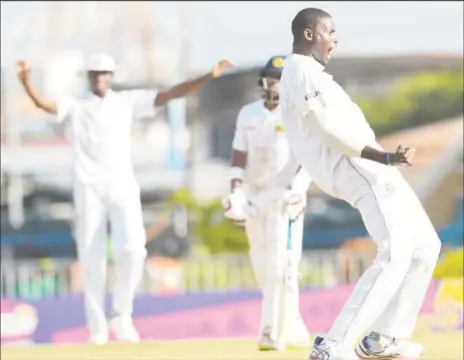  ??  ?? West Indies captain Jason Holder celebrates after capturing the wicket of Angelo Mathews on the fourth day of the opening Test.