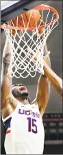  ?? Stephen Dunn / Associated Press ?? UConn’s Sidney Wilson dunks during the first half the Huskies’ 8967 victory over Sacred Heart on Friday in Storrs.