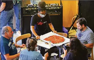  ?? Christian Abraham / Hearst Connecticu­t Media file photo ?? A Sally’s Apizza employee works the tables in October 2021 at the chain’s newest location in Stamford. Connecticu­t logged record job quits that month, but the state’s employment count has increased for six straight months.