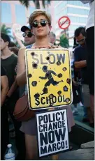  ?? RHONA WISE — GETTY IMAGES ?? Protesters hold signs at a rally for gun control at the Broward County Federal Courthouse in Fort Lauderdale, Florida, in 2018.