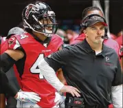  ?? CURTIS COMPTON / CCOMPTON@AJC.COM ?? Falcons linebacker Vic Beasley and coach Dan Quinn stand on the sidelines during the final minutes of the team’s 37-10 loss to the Los Angeles Rams on Sunday.