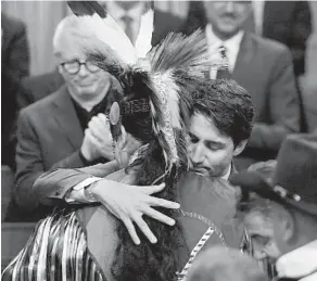  ??  ?? Prime Minister Justin Trudeau hugs a drummer following a performanc­e after delivering a statement of exoneratio­n on behalf of the government to the Tsilhqot'in Nation in the House of Commons on Parliament Hill on Monday.