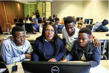  ?? Picture: Simphiwe Nkwali ?? Lindiwe Matlali, centre, founder and CEO of Africa Teen Geeks, an NGO that teaches young people to code.