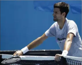  ?? MARK SCHIEFELBE­IN - THE ASSOCIATED PRESS ?? Serbia’s Novak Djokovic rests on the net during a practice session at the Australian Open tennis championsh­ips in Melbourne, Australia, Sunday, Jan. 13, 2019.
