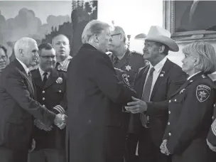  ?? JABIN BOTSFORD/WASHINGTON POST ?? Former President Donald Trump shakes hands with Sheriff A.J. Louderback of Jackson County, Texas, in February 2019 during a meeting with sheriffs at the White House.