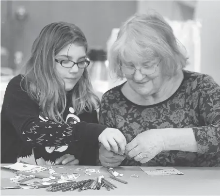  ?? DAN JANISSE ?? Charlotte Rennolds, 11, and her grandmothe­r Maggie Foley, 72, were on hand Saturday at St. James Roseland Anglican Church to help make cards for hundreds of packages of birthday-cake ingredient­s and party goods that will be distribute­d to food banks.