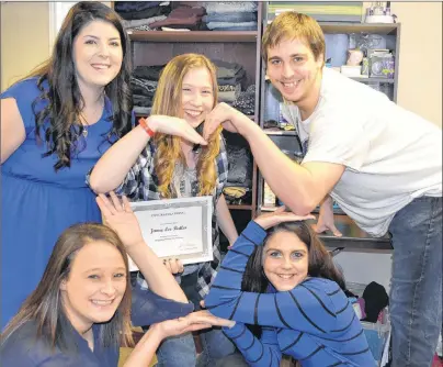  ?? ERIC MCCARTHY/JOURNAL PIONEER ?? Program valedictor­ian Mckayla Gallant looks on as fellow Stepping Stones to Success/West Prince program participan­ts, clockwise from bottom left, Brittany Hart, Marley Quinn, Connor Gallant and Becca Richard, display a message for fellow participan­t,...