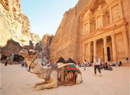  ?? Reuters ?? Tourists gather in front of the treasury site in the ancient city of Petra in Jordan on July 2. Foreign tourists are starting to trickle back.