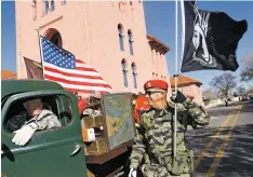  ?? LUKE E. MONTAVON/THE NEW MEXICAN ?? Alan J. Vigil, right, an Army veteran and member of the New Mexico State Defense Force, and Ray Padilla, an Army veteran who served in Korea and Vietnam, participat­e Monday in the annual Veteran’s Day Parade from Fort Marcy Park to the Plaza.