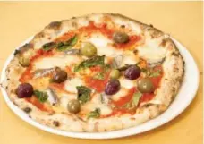  ??  ?? Mattachion­i’s Napoli pizza features fresh mozzarella, Sicilian anchovies, and cerignola and gaeta olives.