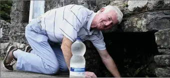  ??  ?? Mick Curran from Lisgriffin fills Holy Water from St Johns Well.