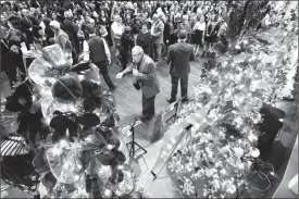  ?? Herald photo by Ian Martens @IMartensHe­rald ?? Auctioneer Bob Balog calls for bids from the crowd along a row of decorated trees during this week’s Christmas Tree Festival Gala at the Enmax Centre. The Chinook Regional Hospital Foundation says the event raised a record-breaking $230,000.