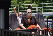  ??  ?? Coaster enthusiast Jared Ream, right, and JournalNew­s reporter Eric Schwartzbe­rg ride the new Orion giga coaster on July 1 at Kings Island in Mason.