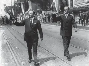  ?? FILE ?? James M. Cox, Democratic nominee for president, left, and his running mate, Franklin Delano Roosevelt, right, march in a parade campaignin­g in 1920.