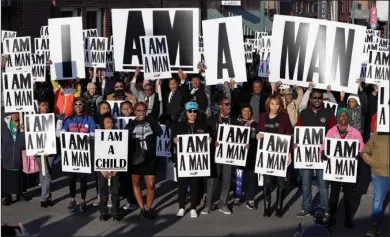  ?? The Associated Press ?? COMMEMORAT­ION: People hold signs resembling the placards carried by striking sanitation workers in 1968 as they join in events commemorat­ing the 50th anniversar­y of the assassinat­ion of the Rev. Martin Luther King Jr. on Wednesday in Memphis, Tenn....