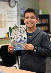  ?? Jerry Baker ?? Landon Hayek, 9, left, a fourth-grader at Creekview Elementary School shows off a copy of “They Called Him Harvey,” a book about Hurricane Harvey that he co-authored and illustrate­d with his mom Jennifer.