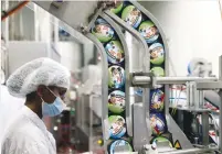  ?? (Ronen Zvulun/Reuters) ?? TUBS OF Ben & Jerry’s ice cream are processed by a worker at the company’s factory in Be’er Tuviya last year.