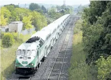  ?? BOB TYMCZYSZYN/POSTMEDIA NEWS ?? A GO train passes under the bridge in Merritton as it makes way out of Niagara.