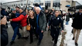  ?? AP ?? Democratic presidenti­al candidate Senator Bernie Sanders, I-Vt., accompanie­d by his wife Jane Sanders, depart after meeting people outside a polling place where voters cast their ballots in a primary election, in Manchester, New Hampshire.