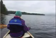  ?? JO BOOKS VIA AP ?? Elizabeth Stevens paddles along the western edge of the First Connecticu­t Lake near the headwaters of the Connecticu­t River, northeast of Pittsburg, N.H.