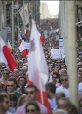  ?? RENE ROSSIGNAUD — THE ASSOCIATED PRESS ?? People march during a rally to honor anti-corruption reporter Daphne Caruana Galizia, killed by a car bomb on Oct. 16, in the capital city of Malta, Valletta, Sunday.