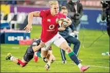  ??  ?? British and Irish Lions’ Duhan van der Merwe, avoids a tackle from South African Sharks’ Thaakir Abrahams to score a try during a warm-up rugby match between South Africa’s Sharks and British and Irish Lions at Ellis Park stadium in Johannesbu­rg, South Africa, on July 7. (AP)