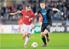  ?? AFP ?? Manchester United’s Bruno Fernandes, left, vies with Club Brugge’s Hans Vanaken in the last-16 first leg in Belgium.