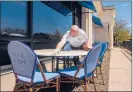  ?? MARK MIRKO/HARTFORD COURANT ?? Max Fish managing partner Brian Costa cleans tables in an outside dining area preparing for state’s May 20 reopening date.