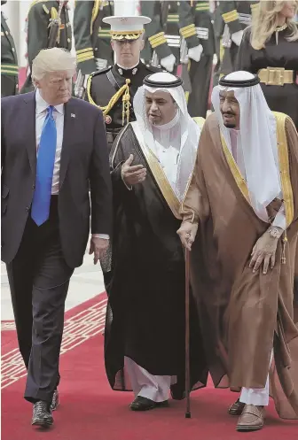  ?? AP PHOTO ?? WARM WELCOME: President Trump, far left, walks with Saudi King Salman, near right, after landing at King Khalid Internatio­nal Airport yesterday in Riyadh.