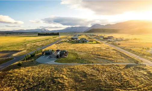  ??  ?? THIS PAGE (from top) The master bedroom wing glows at night. The holiday home sits neatly on the plains on the outskirts of Twizel; the town was built in 1968 for constructi­on workers on the Upper Waitaki hydroelect­ric scheme.